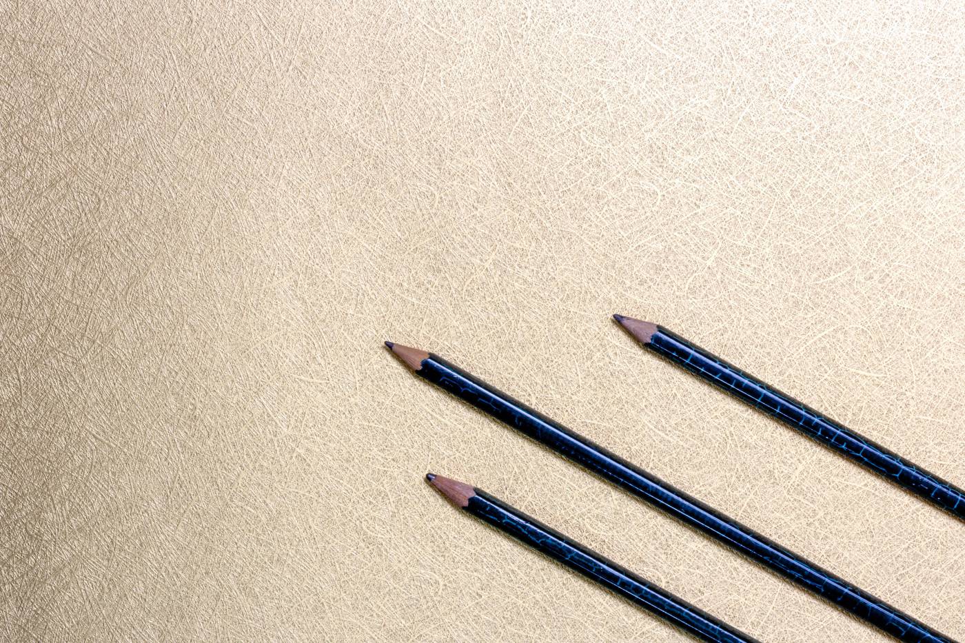 Gold Pencils on Elegant Paper: A Creative Workspace Delight picture