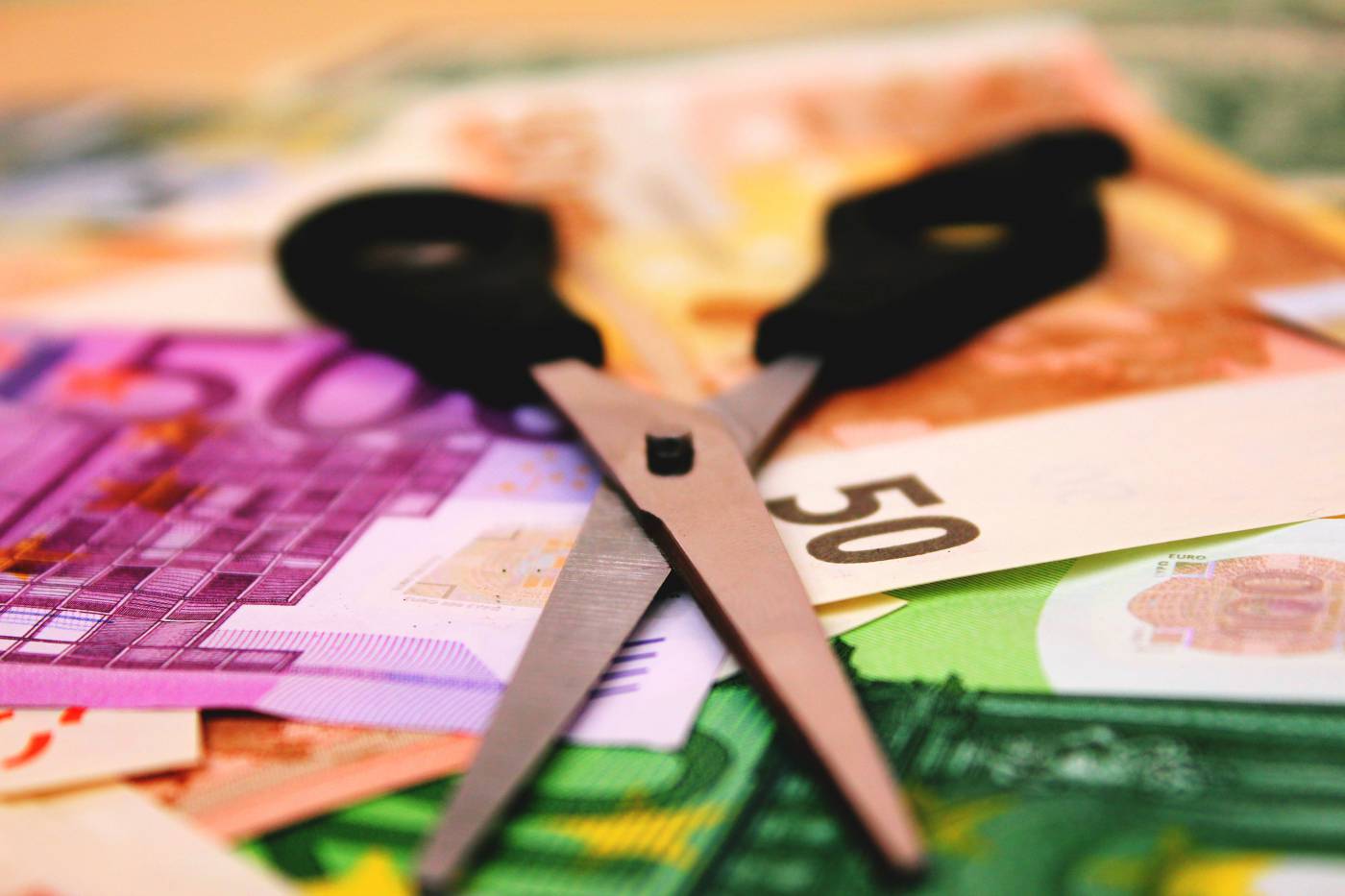 Scissors Cutting Money - Creative Financial Concept Image picture
