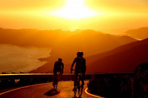 Men Cycling at Sunset 